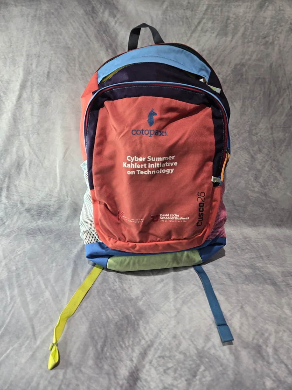 cotopaxi Red Multicolor Cusco25 Backpack with Blue and Yellow Accents